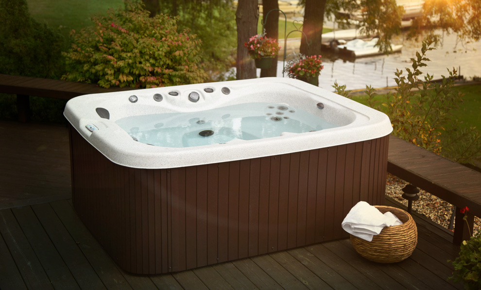 A family enjoying a getaway series hot tub by master spas