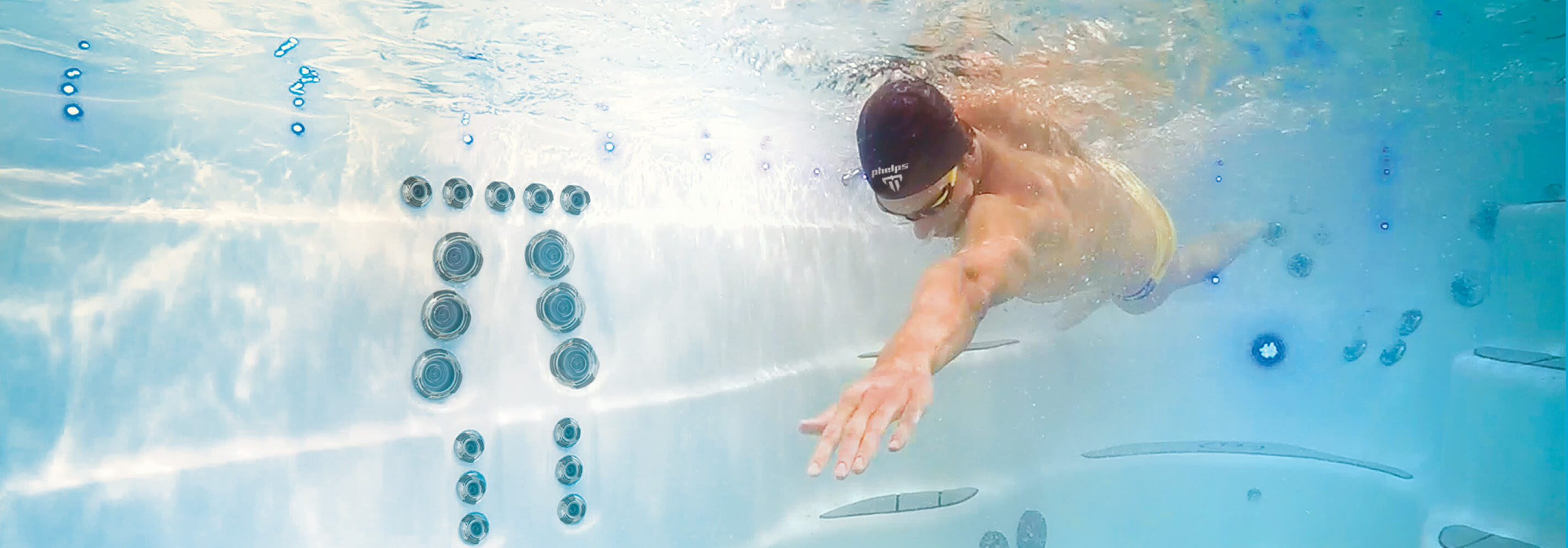 Michael Phelps swimming in a Michael Phelps Signature Swim Spa by Master Spas