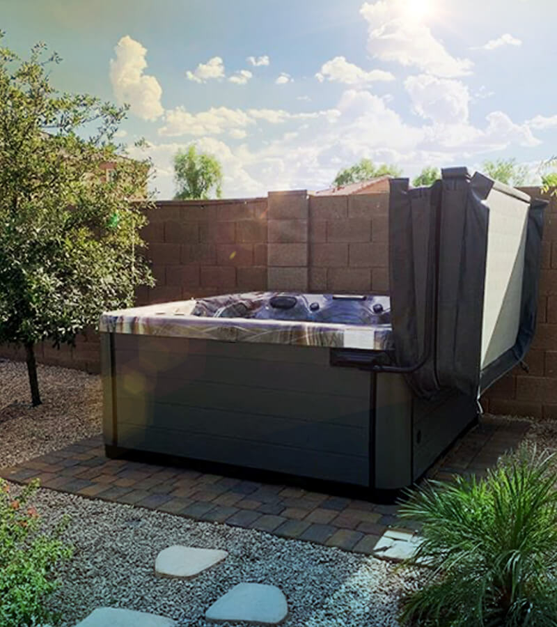 Trees offer shade while large stones create a path to the hot tub