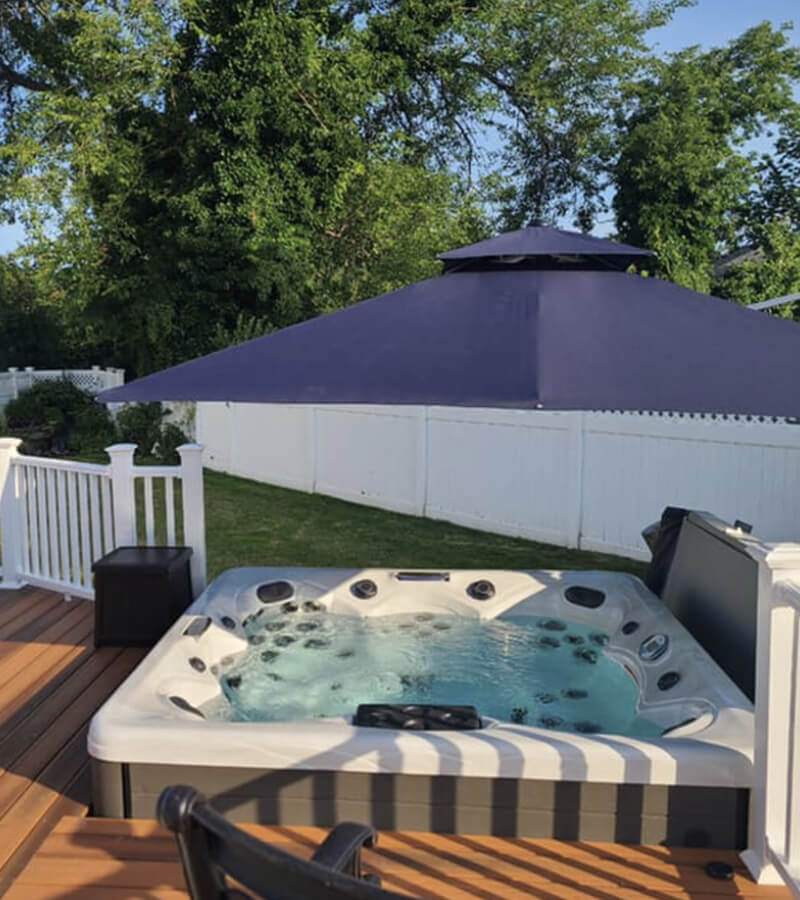 A deck around the hot tub creates the look of an in-ground spa