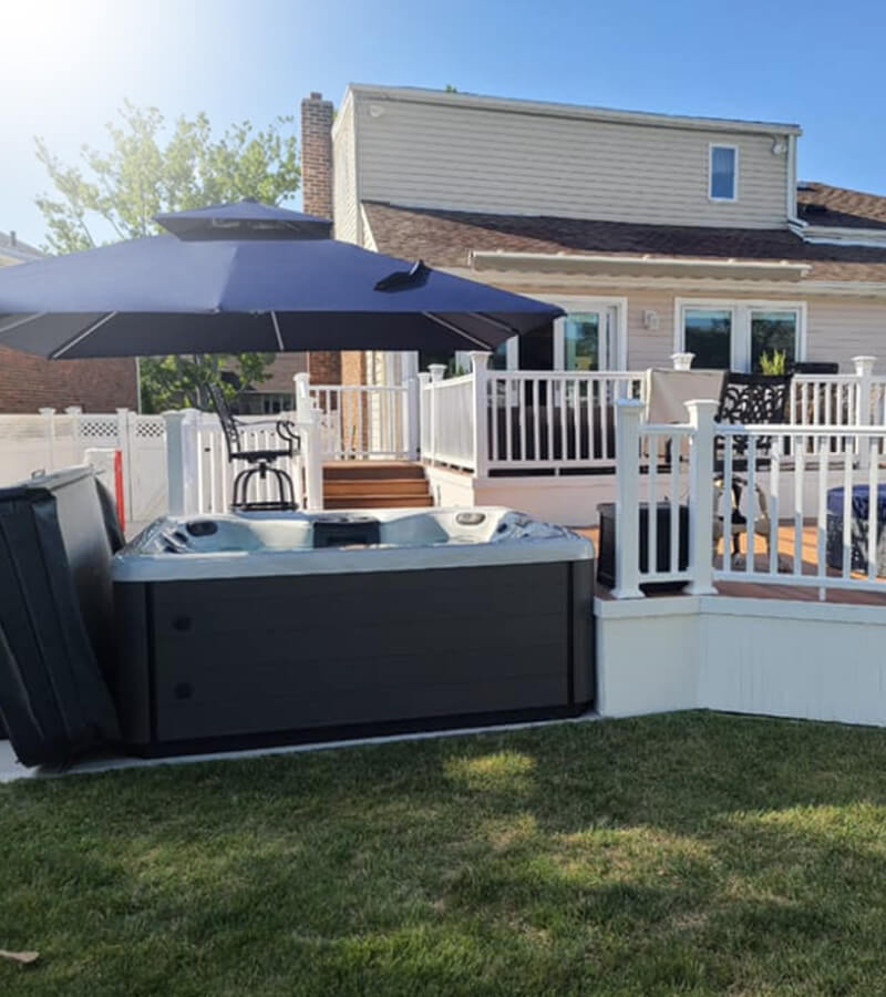 An offset umbrella offer shade to people in the hot tub