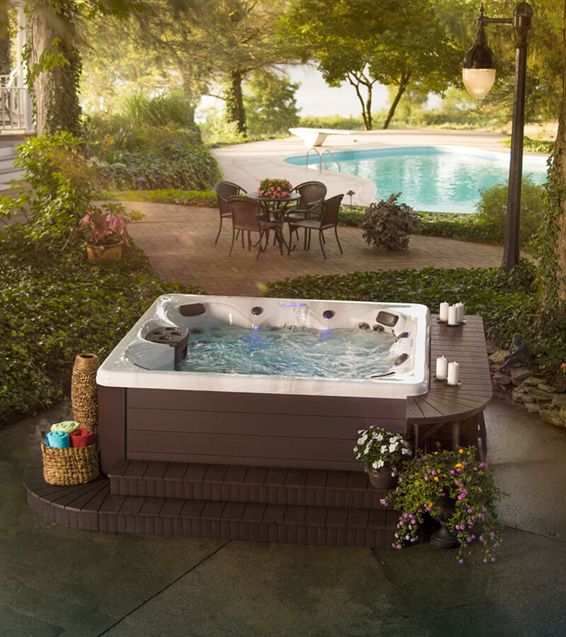 A bar table next to the hot tub offers a space for drinks and cooling off